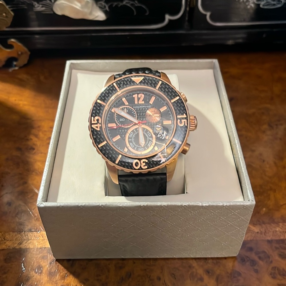 Morphic rose gold watch with black band.